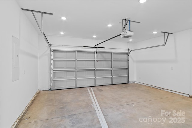garage featuring recessed lighting, a garage door opener, and baseboards