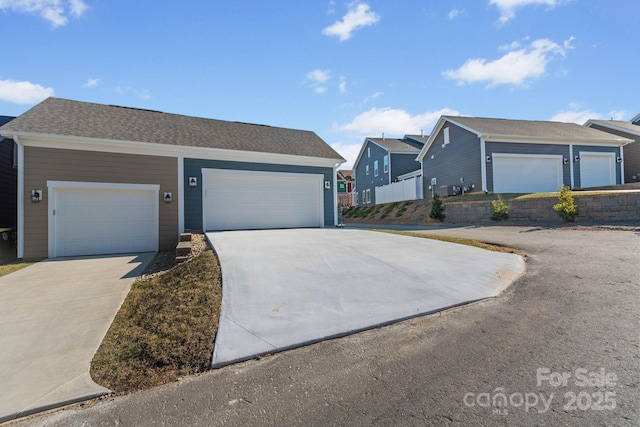 view of front of house with concrete driveway and a garage