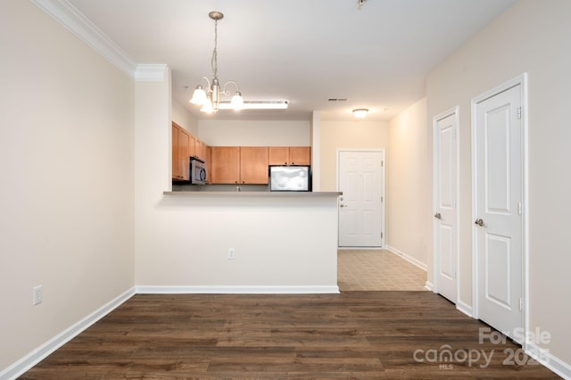 kitchen with fridge, baseboards, an inviting chandelier, dark wood-style flooring, and stainless steel microwave