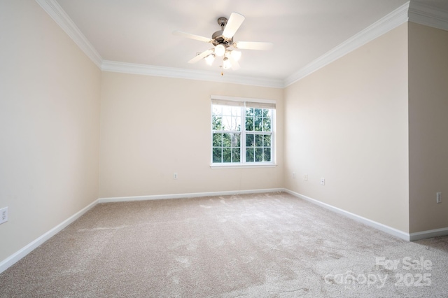 carpeted spare room with ceiling fan, baseboards, and ornamental molding