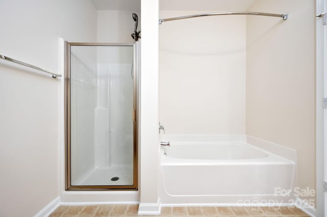 bathroom with a bath and a shower stall