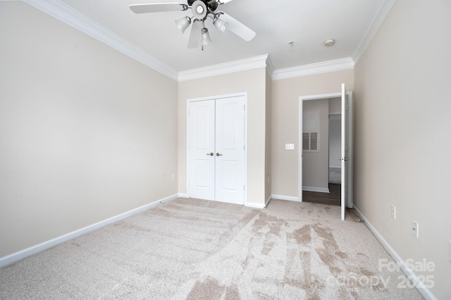 unfurnished bedroom with visible vents, carpet, baseboards, ornamental molding, and a closet