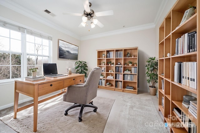 office area with visible vents, carpet floors, a ceiling fan, and ornamental molding