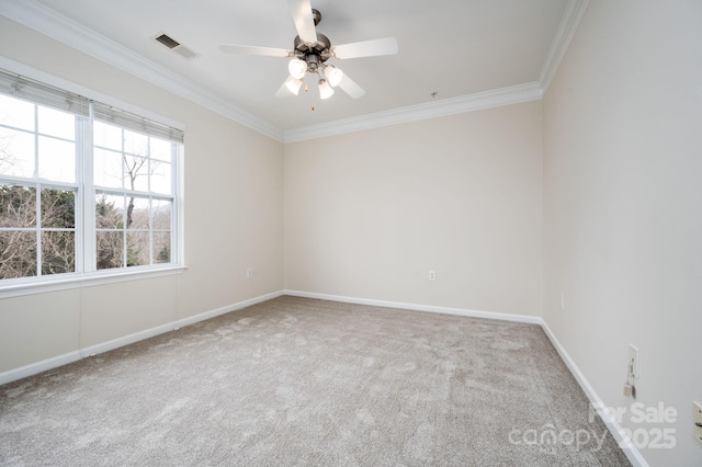 carpeted spare room featuring visible vents, baseboards, a ceiling fan, and crown molding