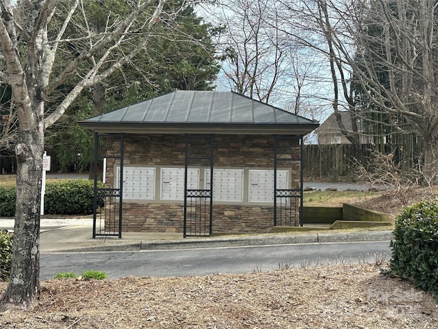 view of property's community with mail area and fence