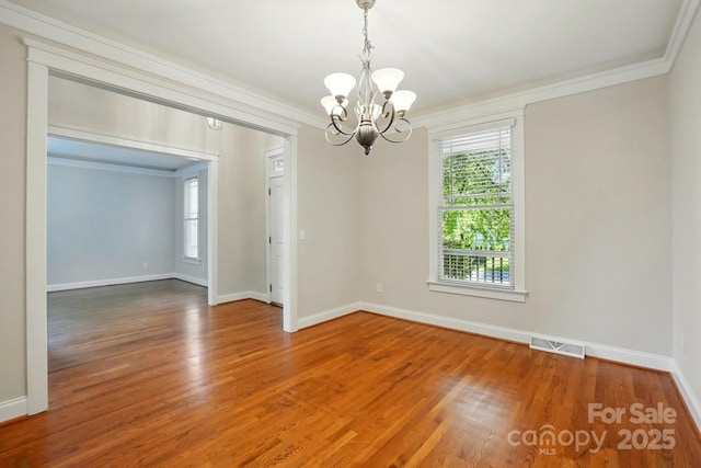 8008 Battersea Ct, Waxhaw, NC 28173 - spare room with crown molding, visible vents, a healthy amount of sunlight, and an inviting chandelier