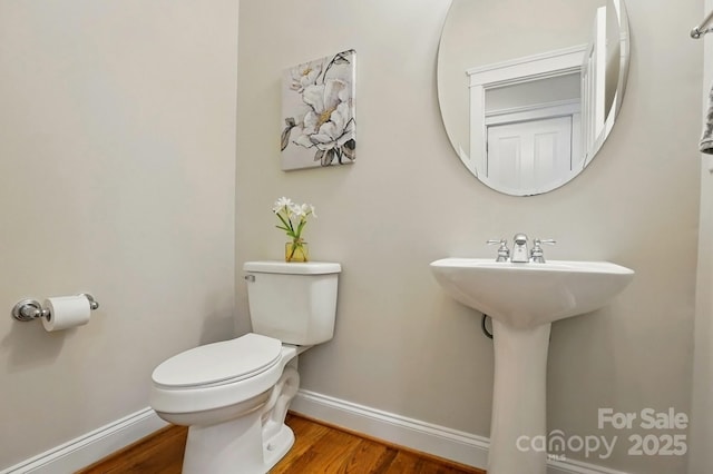 8008 Battersea Ct, Waxhaw, NC 28173 - half bathroom featuring baseboards, wood finished floors, and toilet