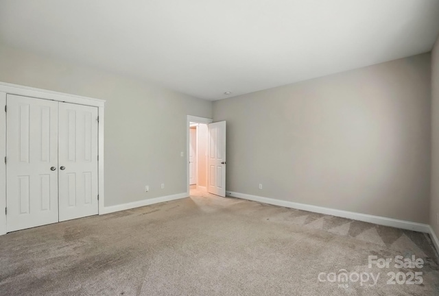 8008 Battersea Ct, Waxhaw, NC 28173 - unfurnished bedroom with baseboards, light colored carpet, and a closet