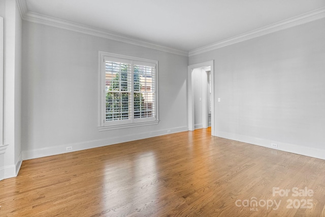unfurnished room with light wood-type flooring, baseboards, and ornamental molding