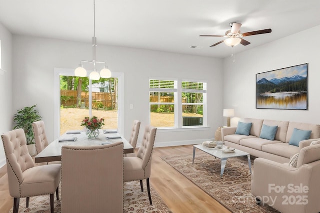 living room with plenty of natural light, ceiling fan, visible vents, and light wood-type flooring