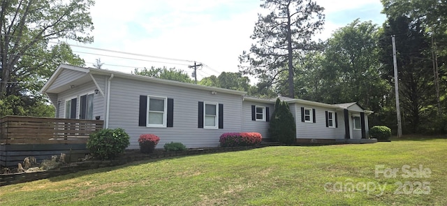 view of front of home with a front lawn and a deck