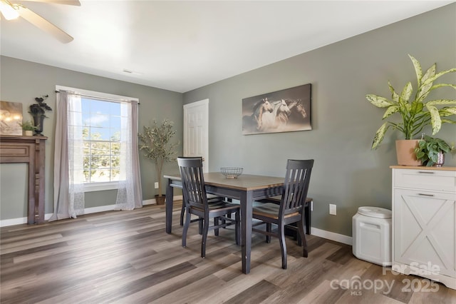 dining space featuring baseboards, a ceiling fan, and light wood-style flooring