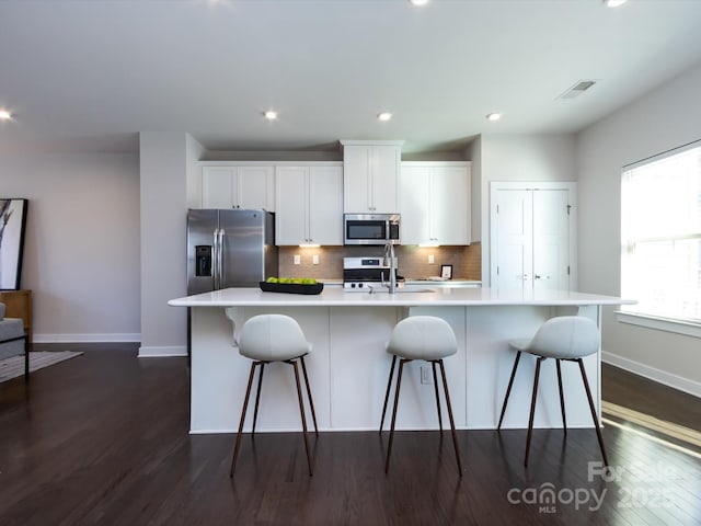 1814 Shumard Ln, Charlotte, NC 28205 - kitchen with visible vents, a sink, appliances with stainless steel finishes, white cabinets, and a large island with sink