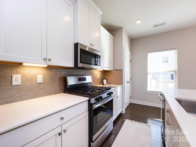 1814 Shumard Ln, Charlotte, NC 28205 - kitchen featuring white cabinetry, light countertops, visible vents, and stainless steel appliances