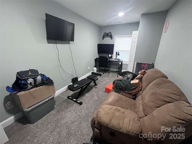carpeted living room featuring baseboards