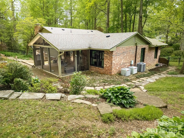 95 Ridgewood Pl, Brevard, NC 28712 - back of house with a sunroom, a chimney, roof with shingles, and central AC unit