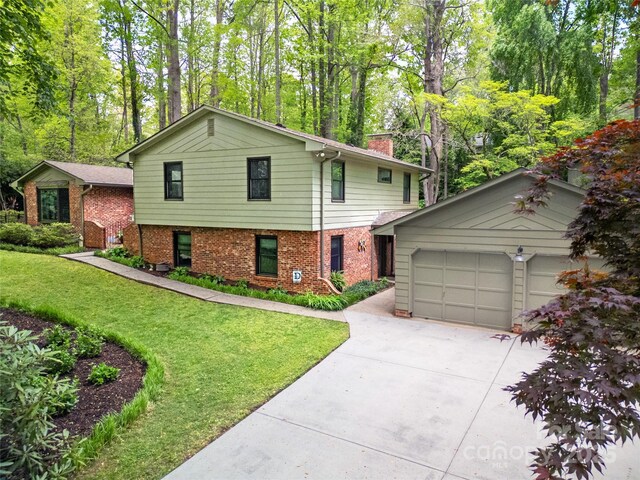 95 Ridgewood Pl, Brevard, NC 28712 - view of front of property featuring a chimney, brick siding, driveway, a front yard, and an attached garage
