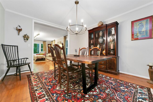 95 Ridgewood Pl, Brevard, NC 28712 - dining room with wood-type flooring, a chandelier, ornamental molding, and baseboards