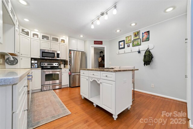 95 Ridgewood Pl, Brevard, NC 28712 - kitchen featuring stainless steel appliances, white cabinets, backsplash, recessed lighting, and a center island
