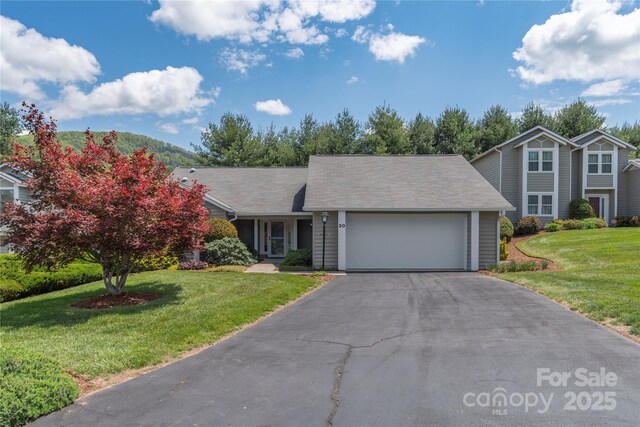30 Cedarcliff Cir, Asheville, NC 28803 - view of front of house with an attached garage, driveway, and a front lawn