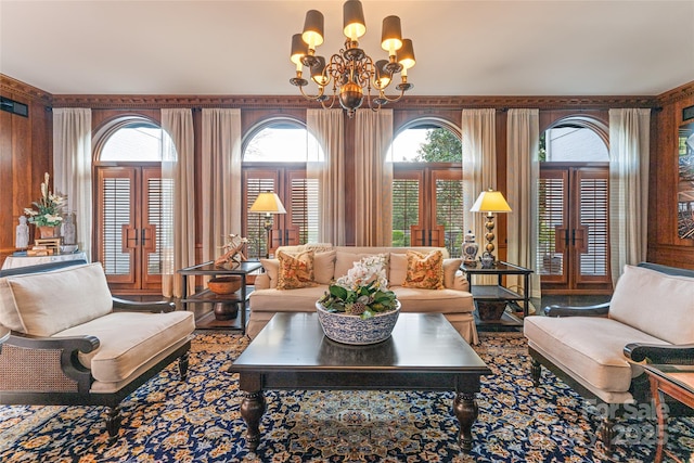living area with french doors and a chandelier