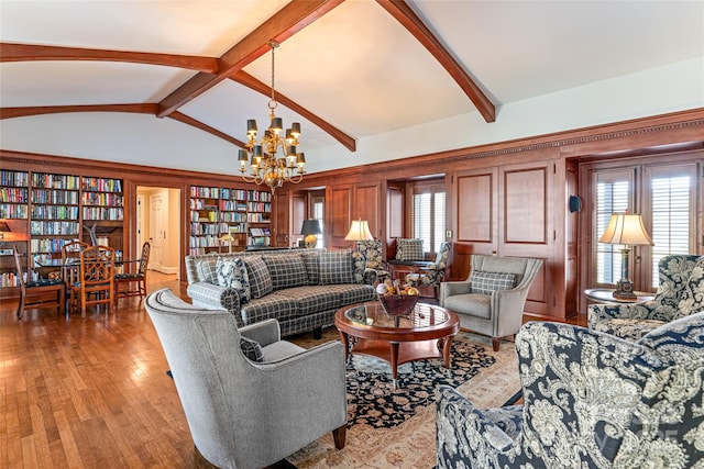 living room with light wood-style flooring, a notable chandelier, vaulted ceiling with beams, and a wealth of natural light