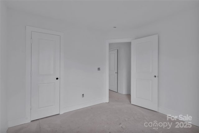 513 Harrel St, Salisbury, NC 28144 - unfurnished bedroom featuring baseboards and concrete floors