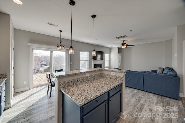 10071 Highland Creek Cir, Indian Land, SC 29707 - kitchen featuring open floor plan, light wood-type flooring, ceiling fan, and visible vents
