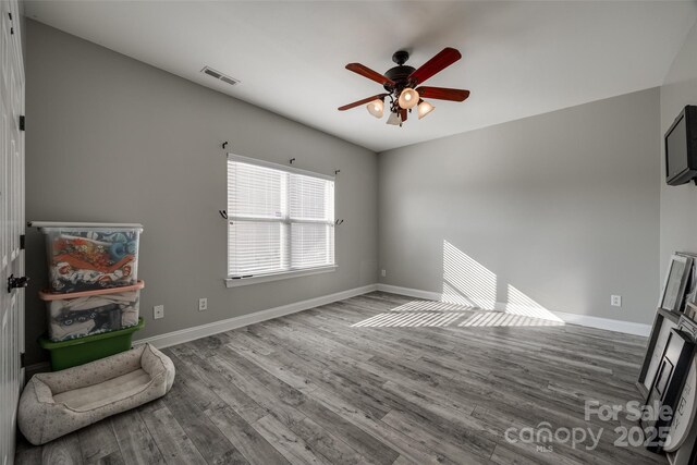 10071 Highland Creek Cir, Indian Land, SC 29707 - unfurnished living room featuring wood finished floors, baseboards, and a ceiling fan