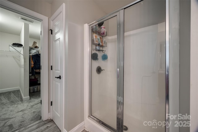 10071 Highland Creek Cir, Indian Land, SC 29707 - full bathroom featuring visible vents, baseboards, a walk in closet, and a stall shower