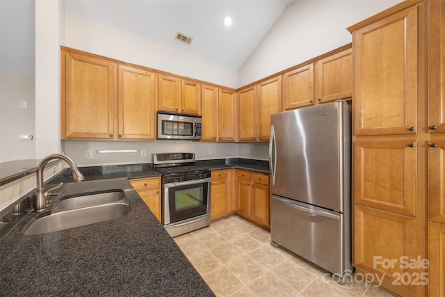 4323 Wiregrass Rd, Indian Land, SC 29707 - kitchen featuring visible vents, a sink, lofted ceiling, dark stone counters, and stainless steel appliances