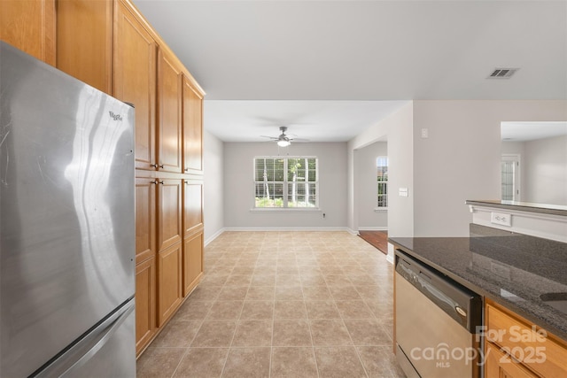 4323 Wiregrass Rd, Indian Land, SC 29707 - kitchen with visible vents, baseboards, dark stone counters, a ceiling fan, and appliances with stainless steel finishes