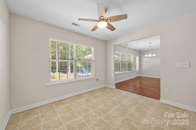 4323 Wiregrass Rd, Indian Land, SC 29707 - empty room featuring visible vents, baseboards, ceiling fan with notable chandelier, and wood finished floors
