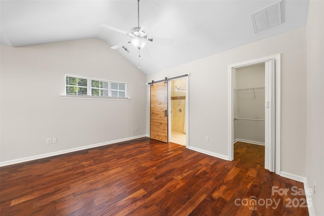 4323 Wiregrass Rd, Indian Land, SC 29707 - unfurnished bedroom with wood finished floors, a walk in closet, a barn door, and visible vents