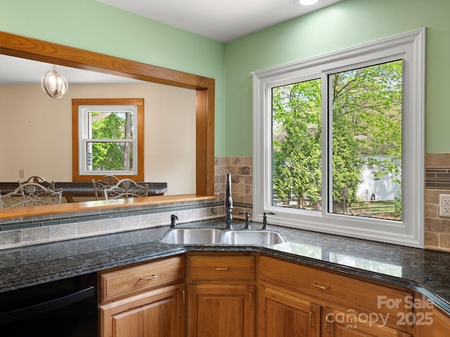 9009 Stourbridge Dr, Huntersville, NC 28078 - kitchen with a sink, black dishwasher, dark stone counters, and backsplash