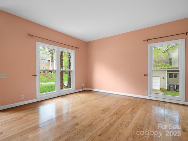 9009 Stourbridge Dr, Huntersville, NC 28078 - unfurnished room with plenty of natural light, light wood-style flooring, and baseboards
