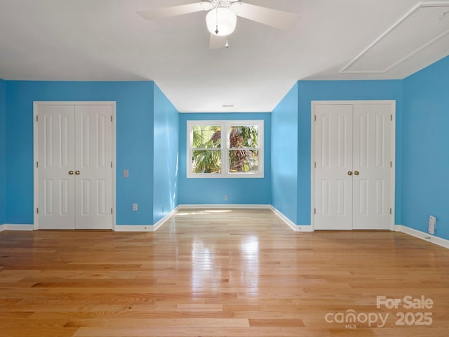 9009 Stourbridge Dr, Huntersville, NC 28078 - unfurnished bedroom with baseboards, wood finished floors, a ceiling fan, and attic access