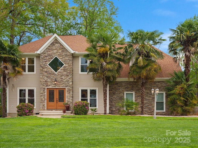 9009 Stourbridge Dr, Huntersville, NC 28078 - view of front facade featuring stone siding, a front yard, french doors, and a shingled roof