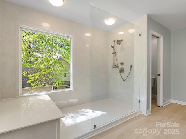 9009 Stourbridge Dr, Huntersville, NC 28078 - bathroom featuring a walk in shower, wood finished floors, baseboards, and toilet