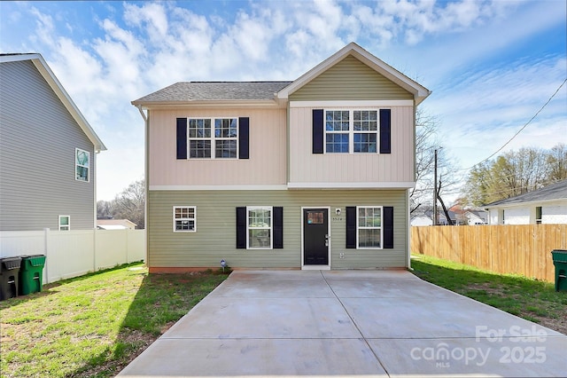 view of front facade featuring a patio area, a front yard, and fence