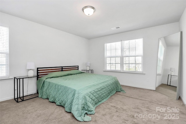 bedroom featuring visible vents, baseboards, and carpet