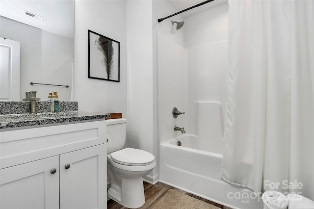full bath featuring visible vents, toilet, wood finished floors, shower / tub combo, and vanity