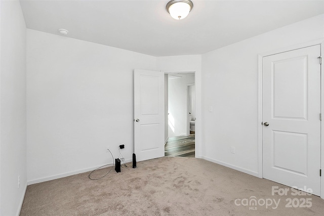 unfurnished bedroom with baseboards and carpet floors