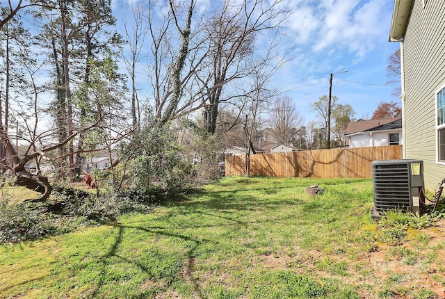 view of yard featuring cooling unit and fence