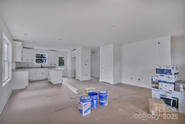515 Harrel St, Salisbury, NC 28144 - unfurnished living room featuring baseboards and a sink