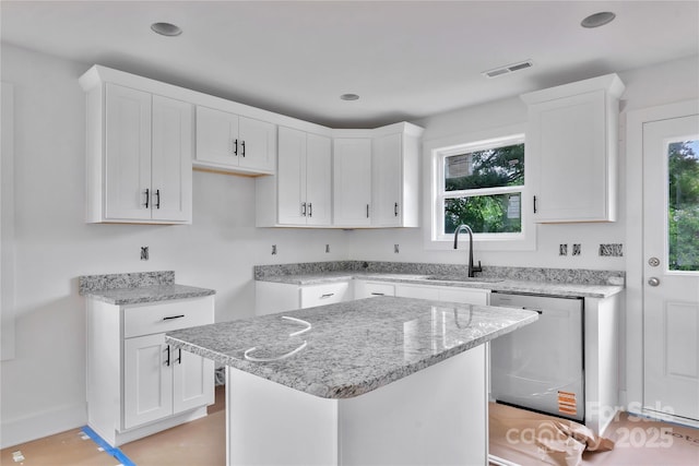515 Harrel St, Salisbury, NC 28144 - kitchen with dishwasher, a sink, light stone countertops, white cabinetry, and a center island