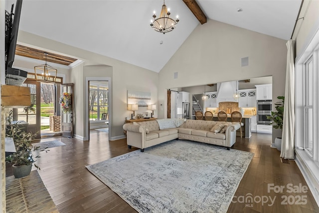 living area featuring dark wood-style floors, high vaulted ceiling, a notable chandelier, and beam ceiling