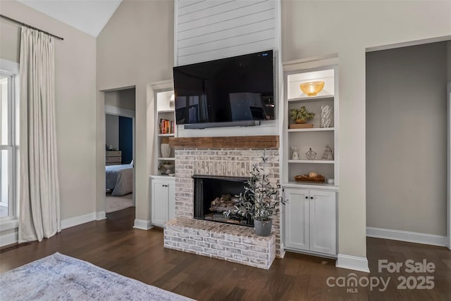 living room with dark wood-style flooring, high vaulted ceiling, baseboards, built in features, and a fireplace