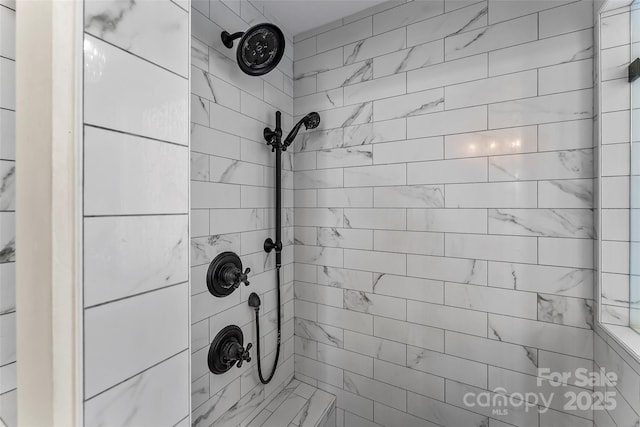full bath with tiled shower