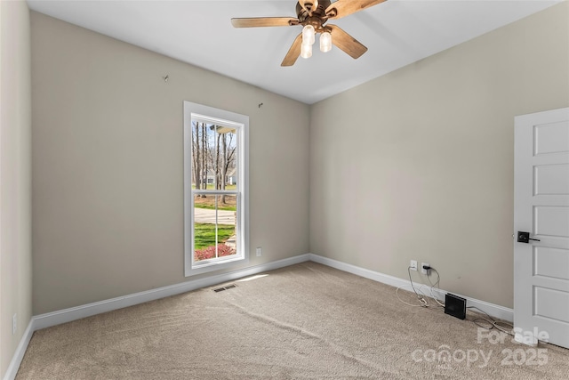 carpeted empty room featuring a ceiling fan, baseboards, and visible vents